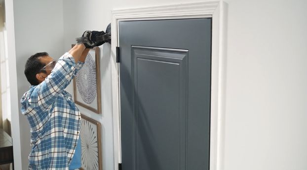 man-using-pry-bar-on-door-casing