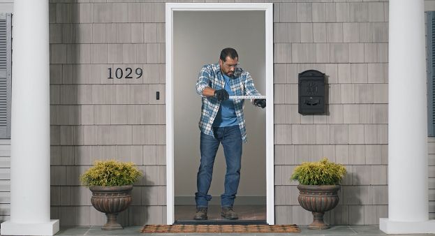 person-measuring-the-width-of-a-rough-opening-on-an-exterior-door