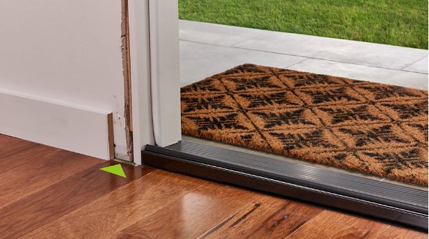 an-arrow-pointing-to-the-subfloor-by-an-exterior-door-with-door-casing-removed