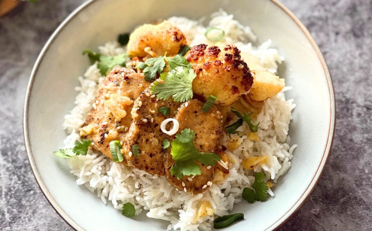 A plate of orange and ginger tofu with rice