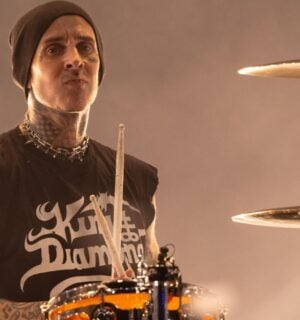 Blink 182 star and vegan celebrity Travis Barker playing the drums on stage